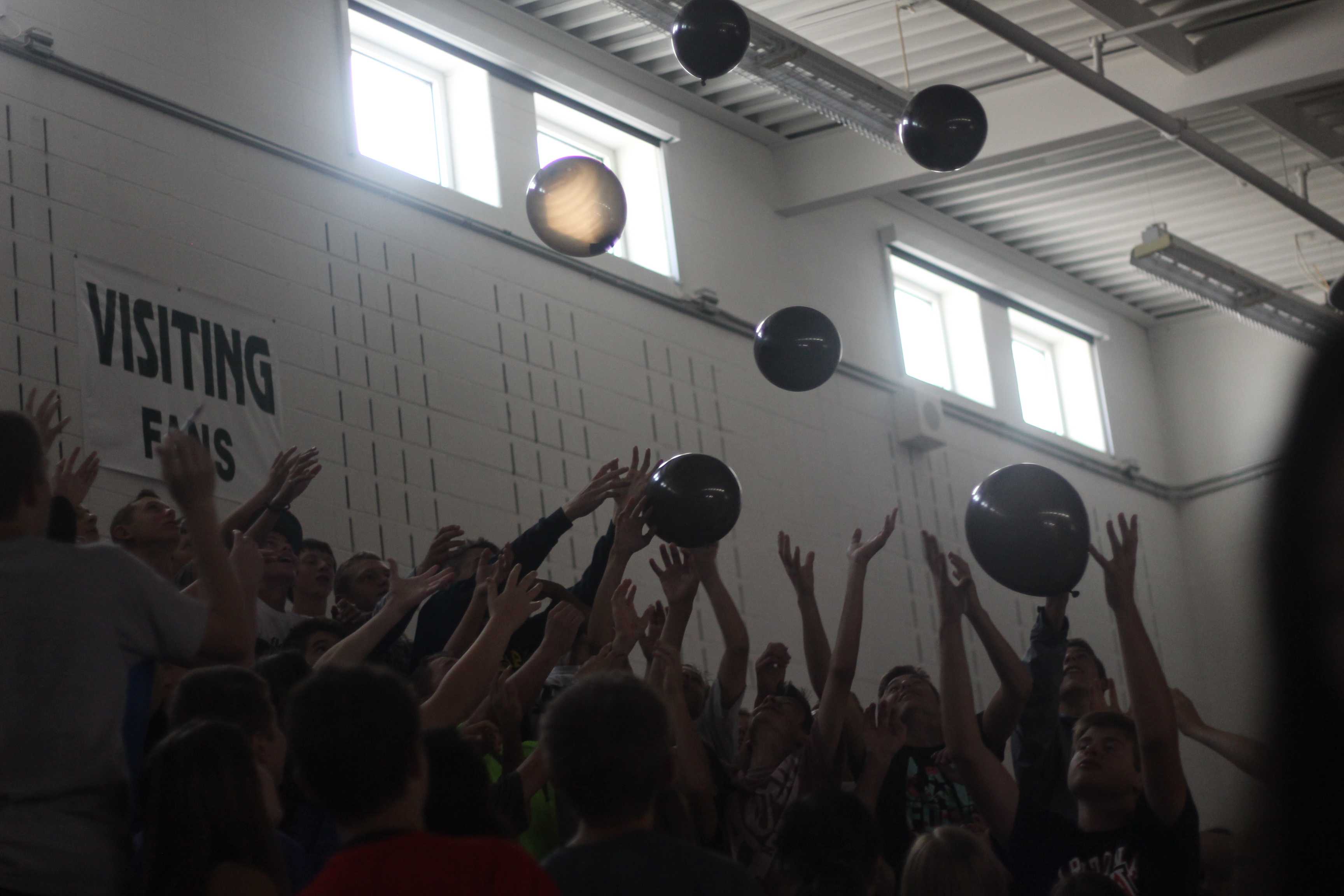 Freshmen reach for the falling balloons.