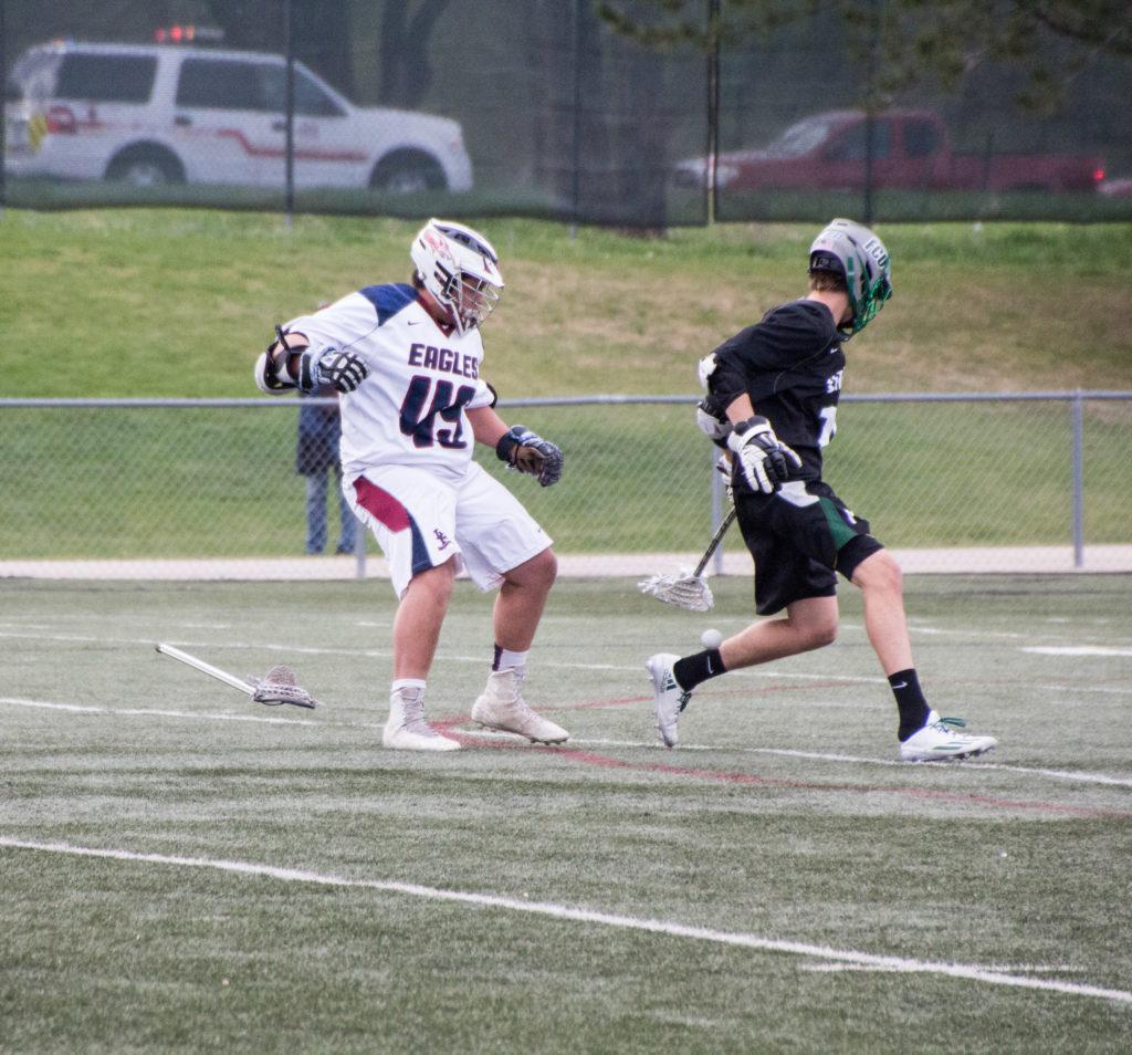 #18 Jake Higdon de-sticking another player while scurrying for a ground ball.