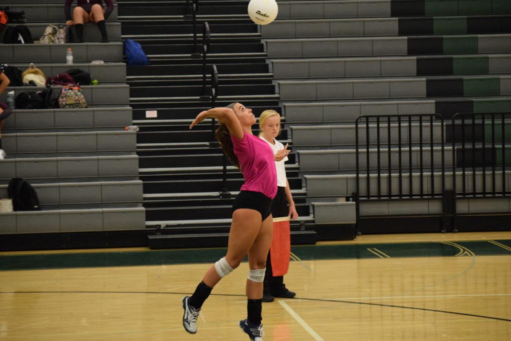 Senior, Lauren Rice serves the ball over the net. Photo Credit: Haley Rockwell