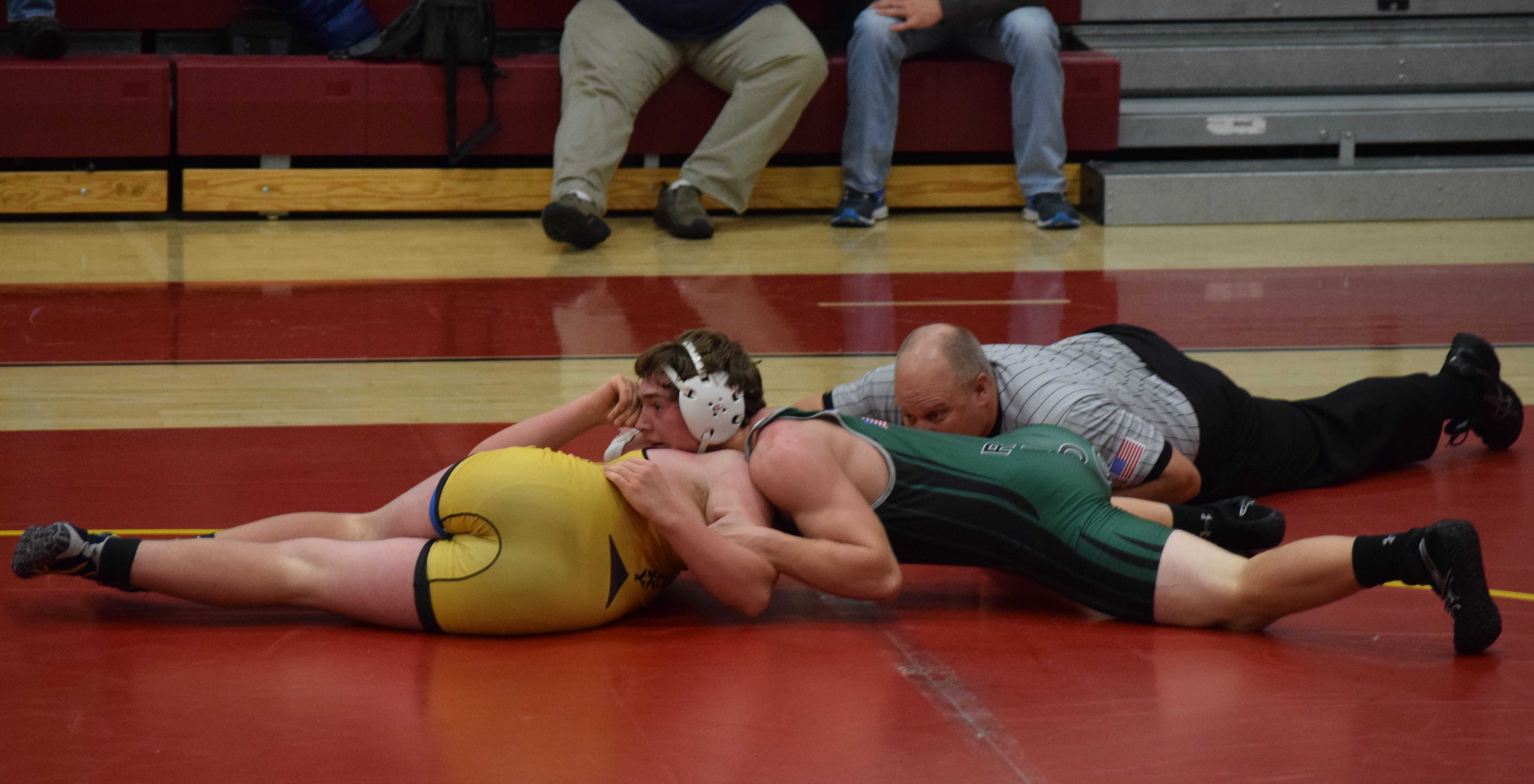 Junior, Nathan Meyer pin his opponent and scores 6 points for the team. Photo Credit: Haley Rockwell