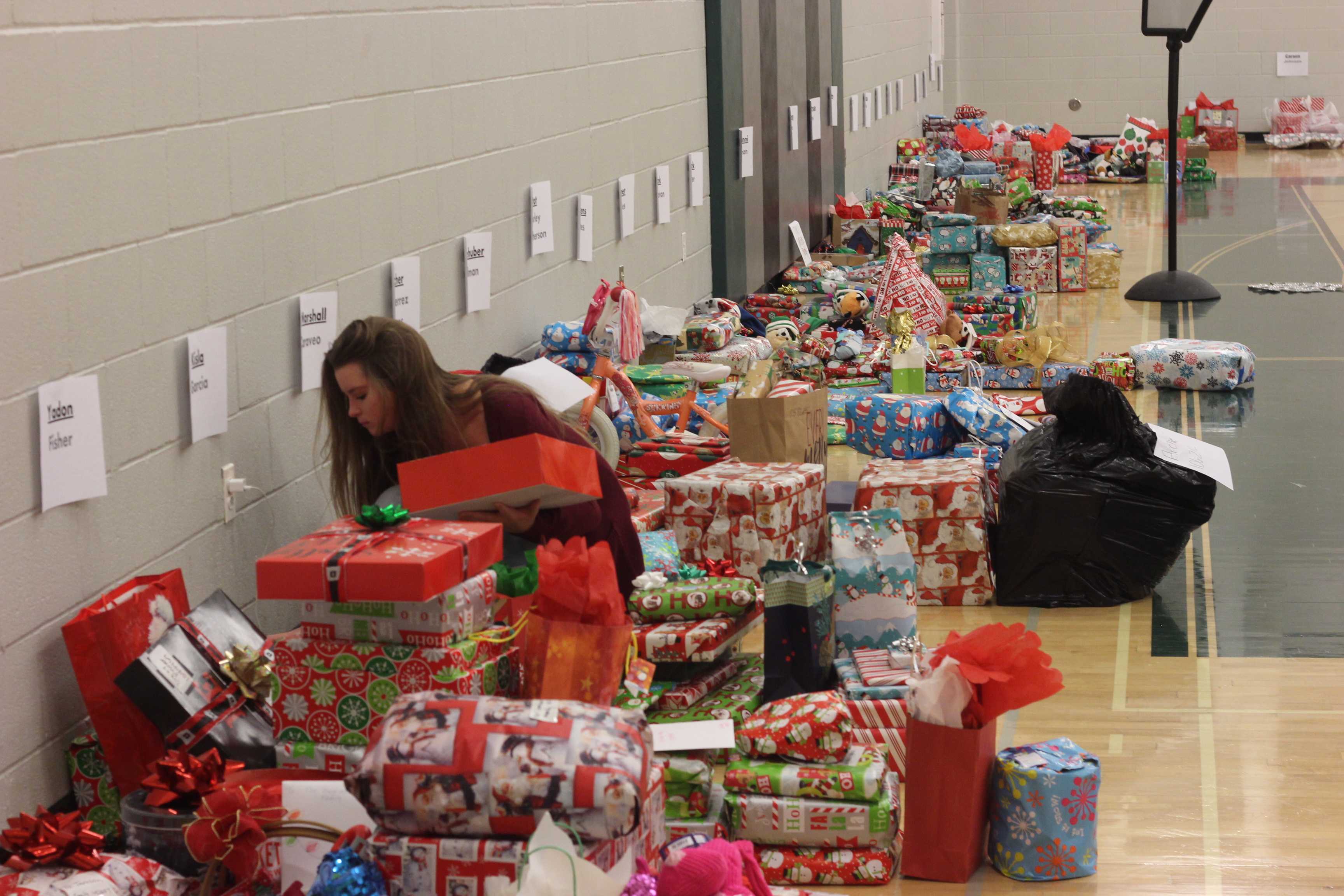 Piles of neatly wrapped gifts surrounded the gym, each dedicated lovingly from advisory to family.
Photo Credit: Cami Corp