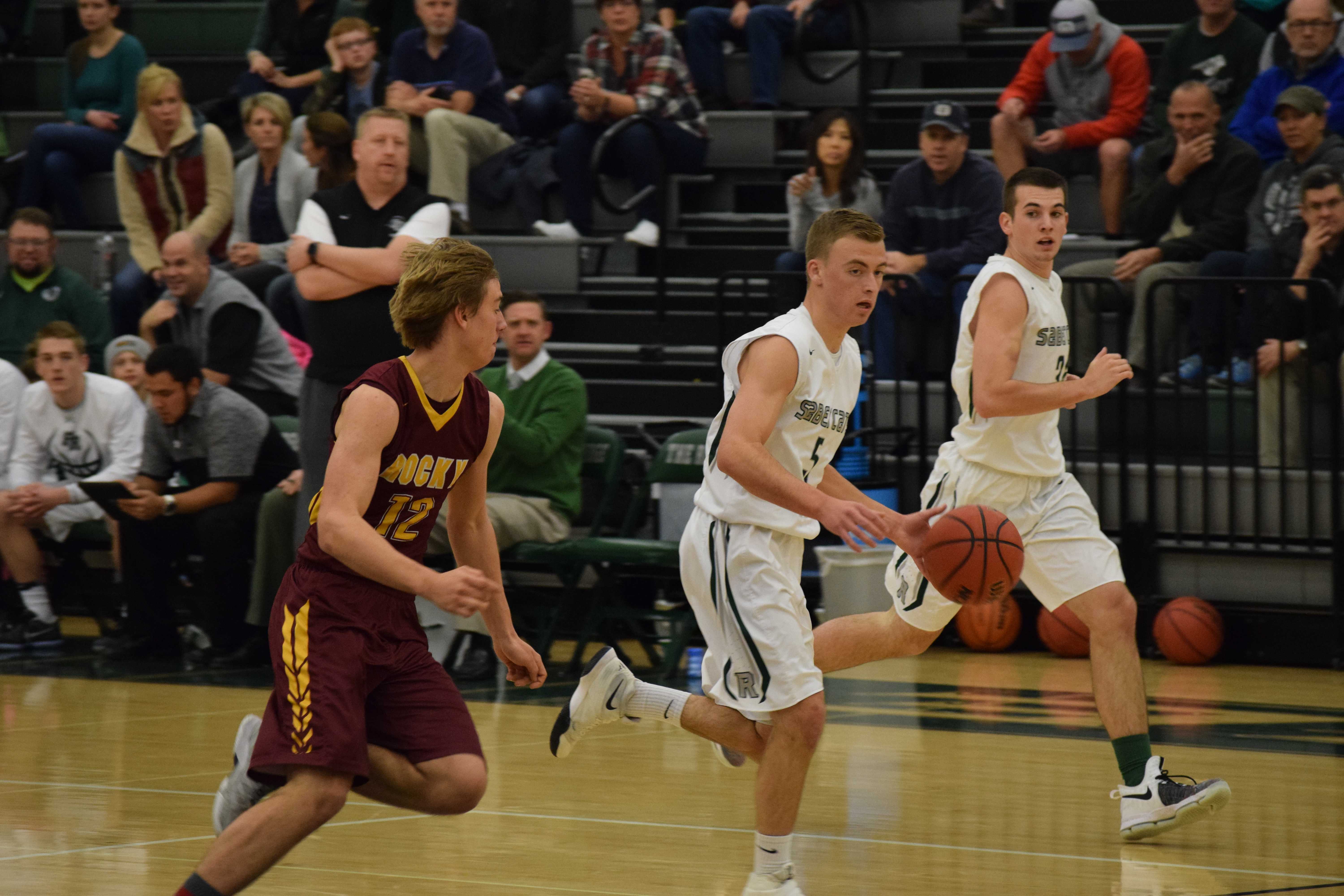 Luke Lauby takes the ball down the court Tuesday January, 17, against cross town rival Rocky Mountain. Photo Credit: Haley Rockwell. 