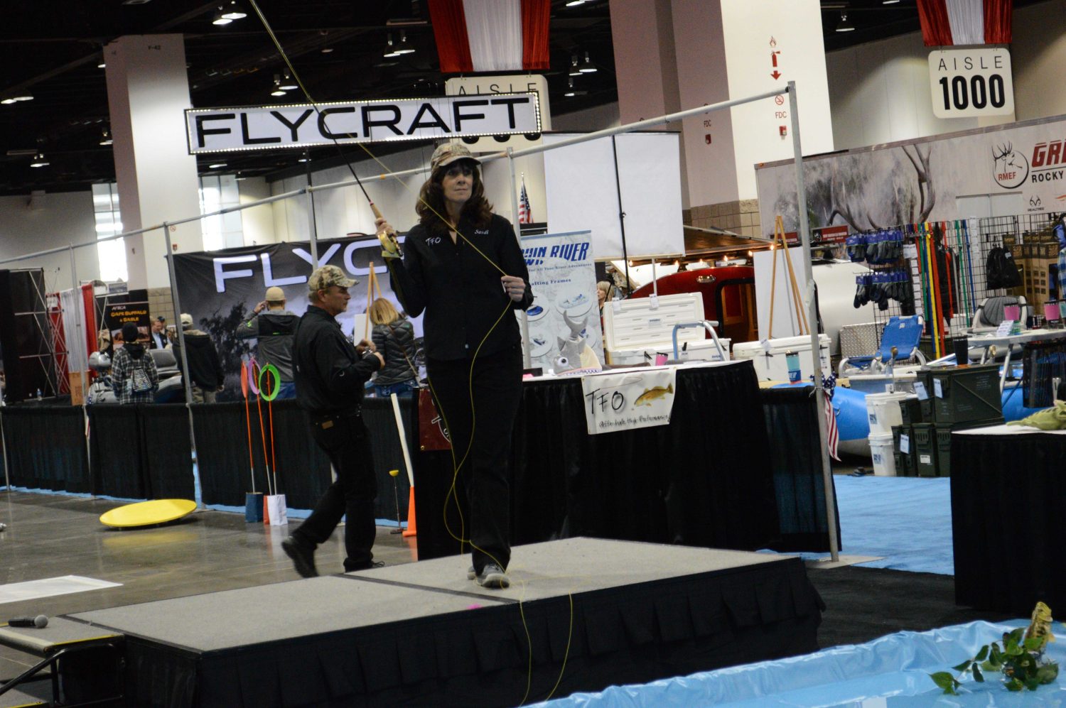 A woman demonstrates fly fishing form during the Sportsmens Expo in Denver, CO. 