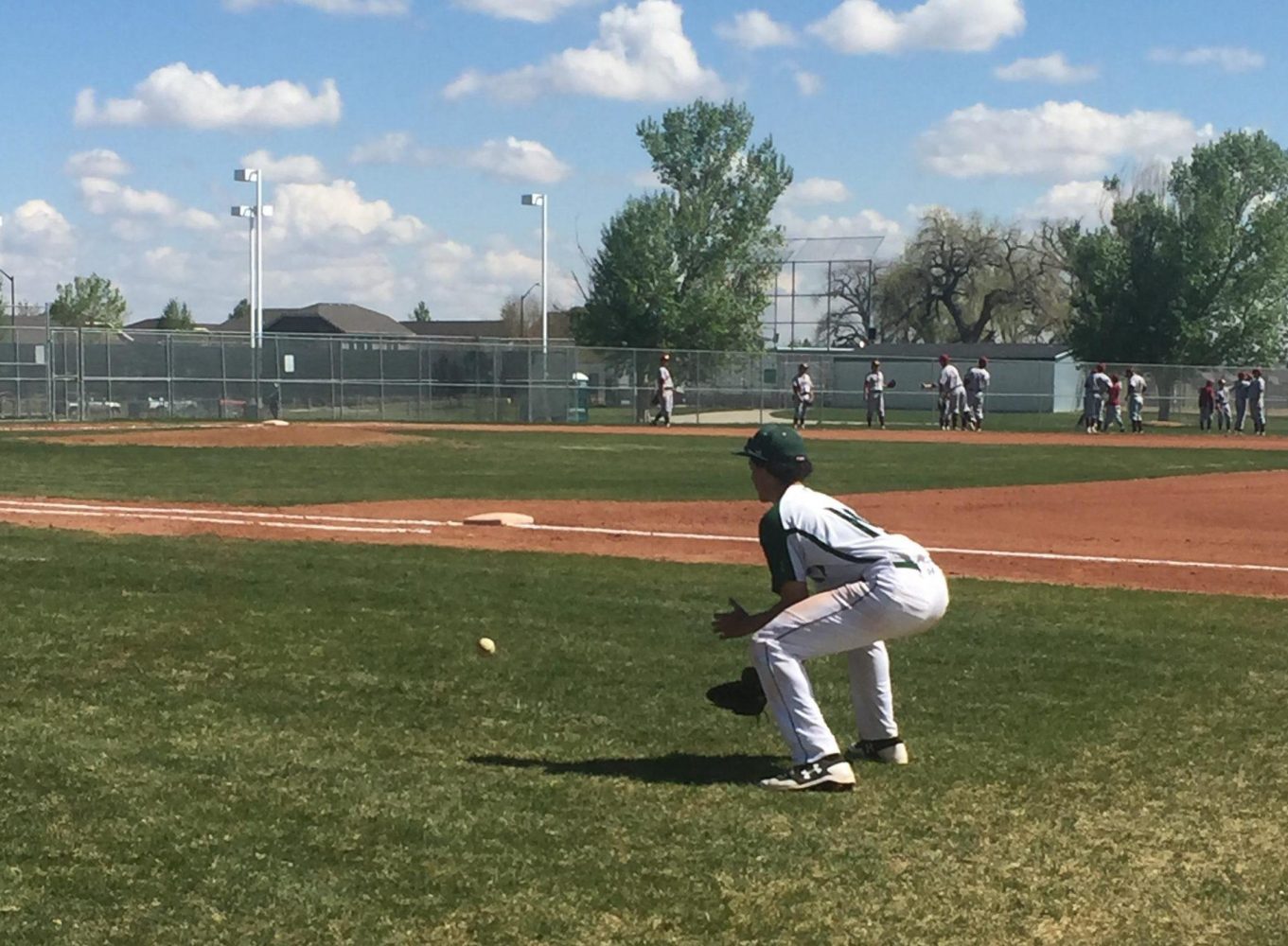 Fossil Ridge varsity baseball warming up on Saturday, April 22, for their game vs Rocky. Photo Credit: Emily Brey