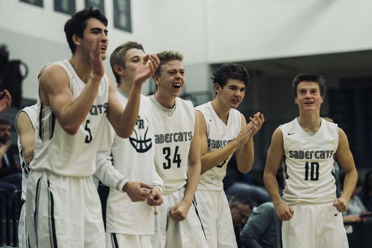 Fossil Ridge High School boys basketball team celebrating after huge play. Brandon Lambrecht, Dylan Whittall, Ethan Henderson, Garrett Ripsam, and Drew Cornmesser featured from left to right. Photo Credit: The Coloradoan. 