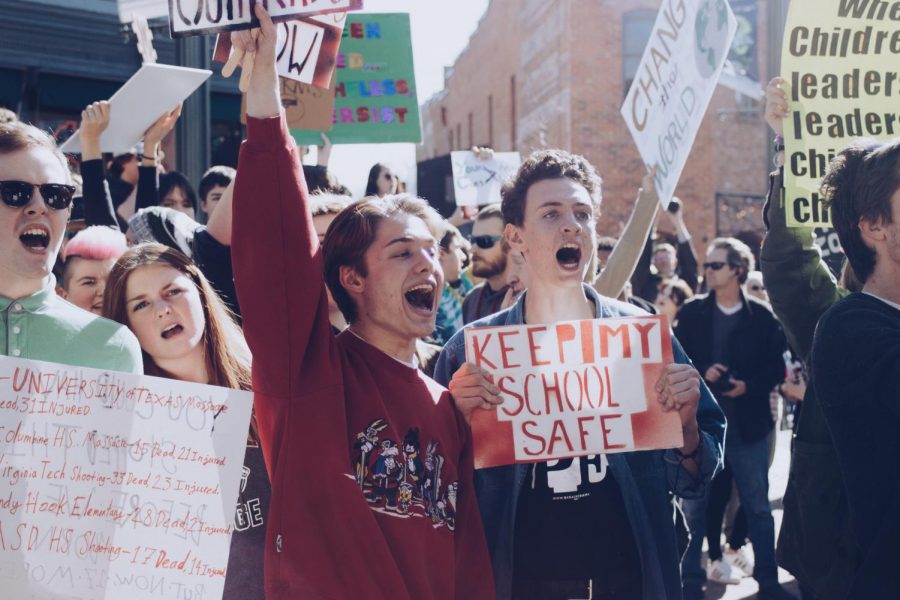 Fossil+students+Grant+DeLuca%2C+Austin+Hand%2C+and+others+held+up+their+own+signs+in+defiance+of+counter-protesters+that+made+an+appearance+after+the+walkout+ended.