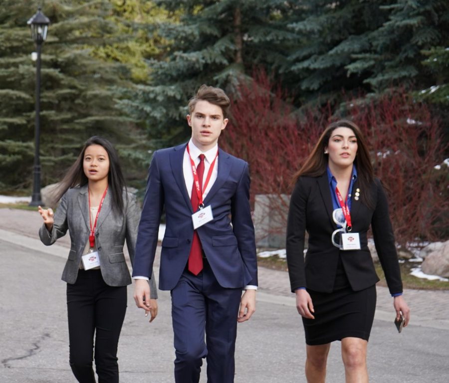 William Cutchin strutting his stuff at the FBLA SLC. Photographed from left to right is Jessica Yang, William Cutchin, and Ashton Reneau. Photo Credit: Alexandre Shappell.