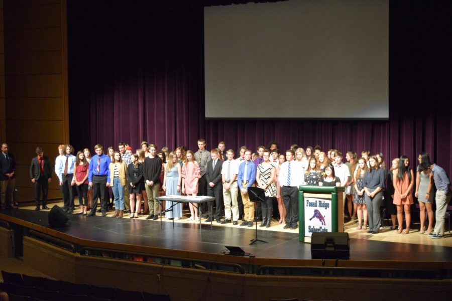 124+new+Tri-M+members+are+called+to+the+stage+one+at+a+time+to+be+inducted.