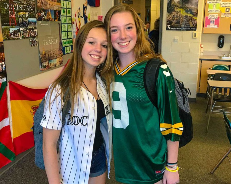 Lucy Allen and Jordan Morris smile in their sports jersey on Monday
