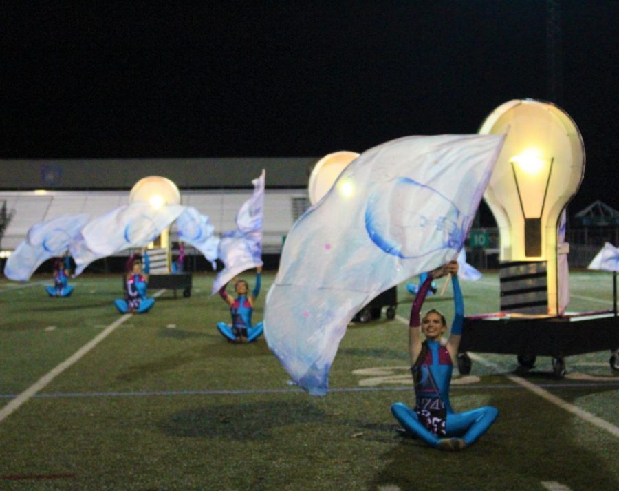Color Guard continues to add an interesting flare to field shows, pictured here with one of their sets of flags depicting light bulbs. This year, the flags each went along with the theme of Enlightenment, the overlying concept of the show. 