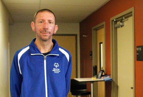 Kyle Emery poses in a Special Olympics jacket. 

