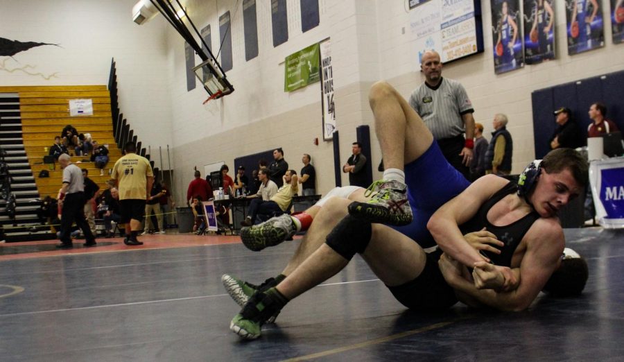Ginther pins his opponent to the mat. 