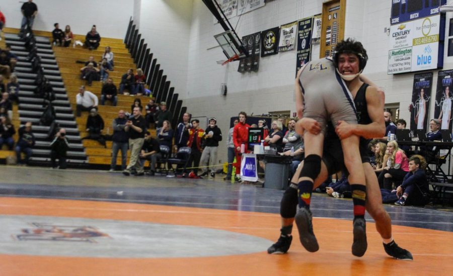 Bolduc lifts his opponent from Legacy High School before slamming him down onto the mat during his first match on Friday. 