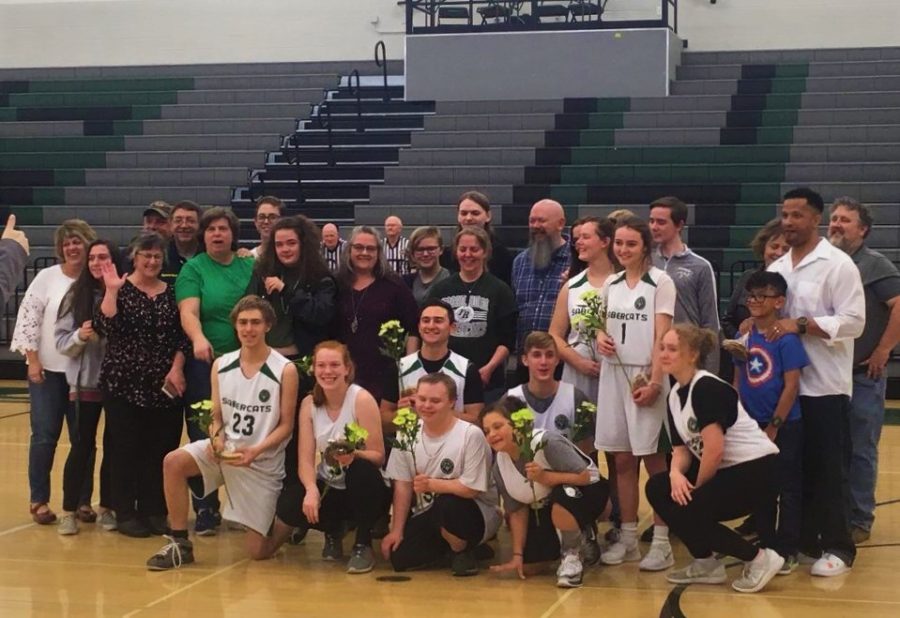 The seniors—myself included—and their families gather for a photo before the start of Mondays game. 