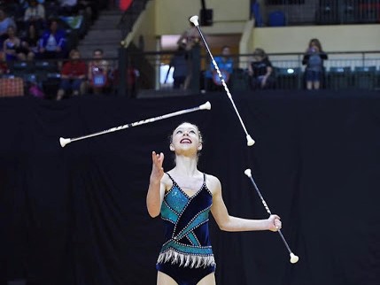 Anderson twirls three batons at once for a competition