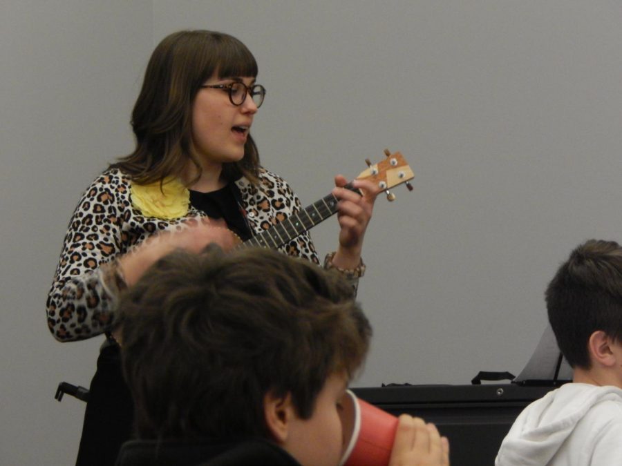 Danielle shows the attendees how to play certain chords. 