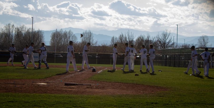The Fossil varisty baseball team rushes to celebrate with each other on Tuesday after their win against Legacy. 