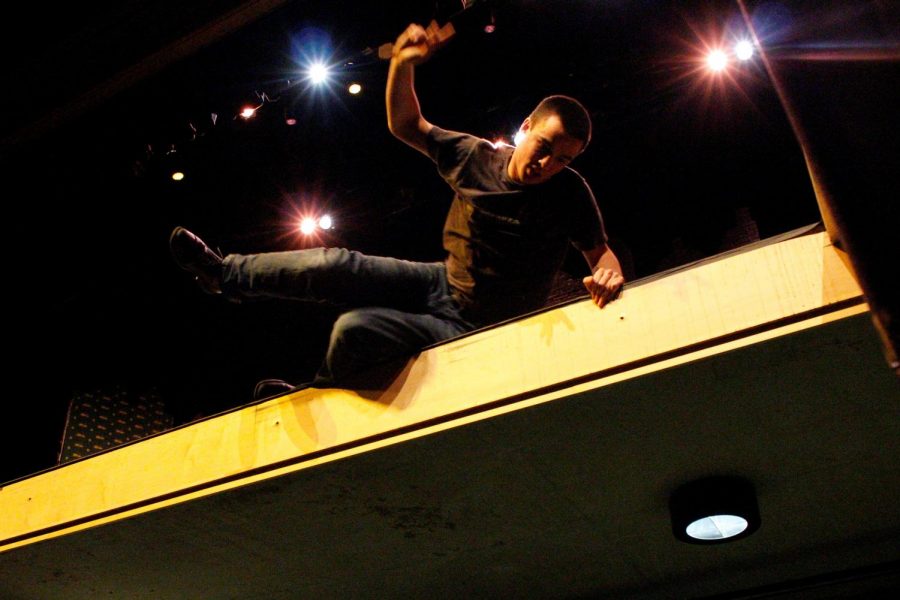 Actor Ben Ashby stages a fall during a show rehearsal.