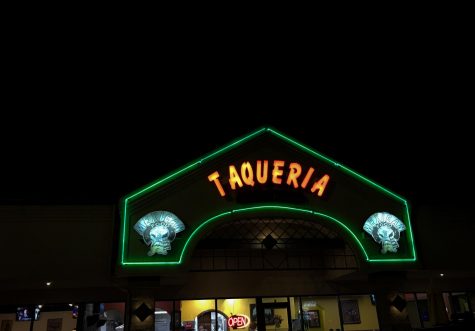 The neon lights welcoming Taqueria Los Comales customers into the restaurant