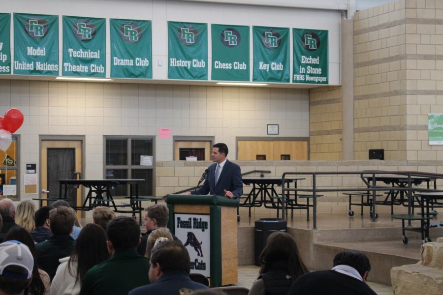 Athletics director Brandon Carlucci addresses the audience and the athletes before signing day commences
