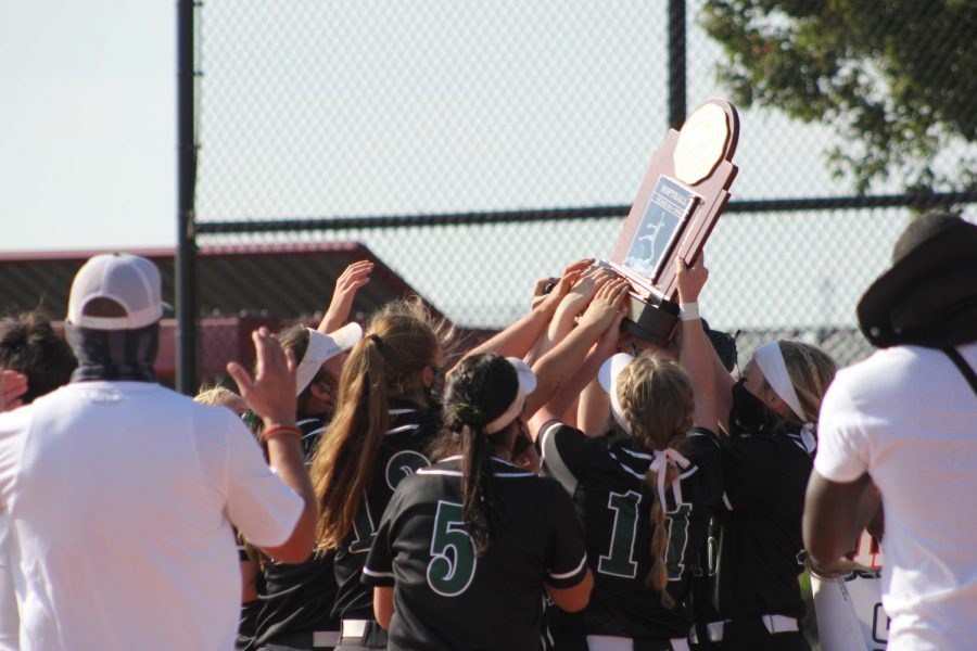 Sabercats gather to hold their trophy celebrating Fossils  first softball state championship.
