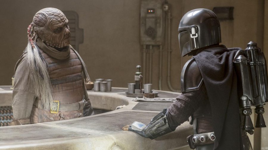 The Mandalorian asks the Weequay bartender if he has seen another Mandalorian in Mos Pelgo.