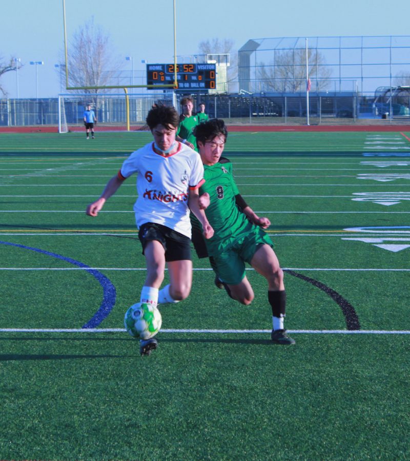 Quinn Ybarro lunges into his opponent to gain control of the ball. 