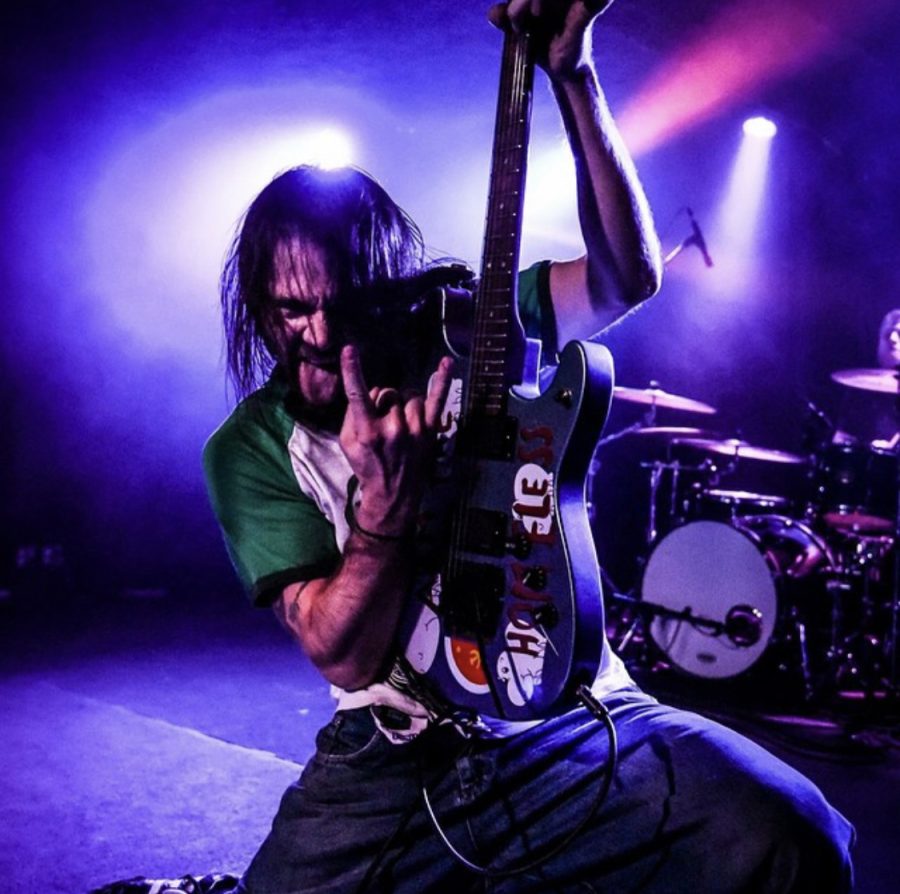 Mike Shamrock of 20XIII shredding on guitar at a gig, January 2019