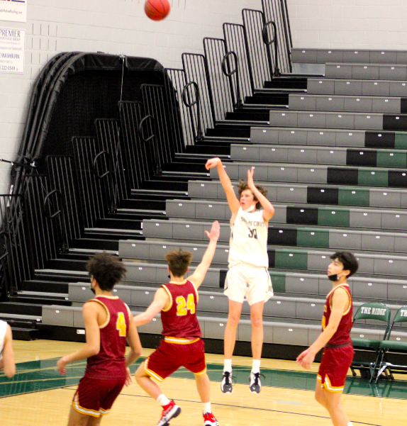Junior, Drew McMillan launches a three from the corner.
