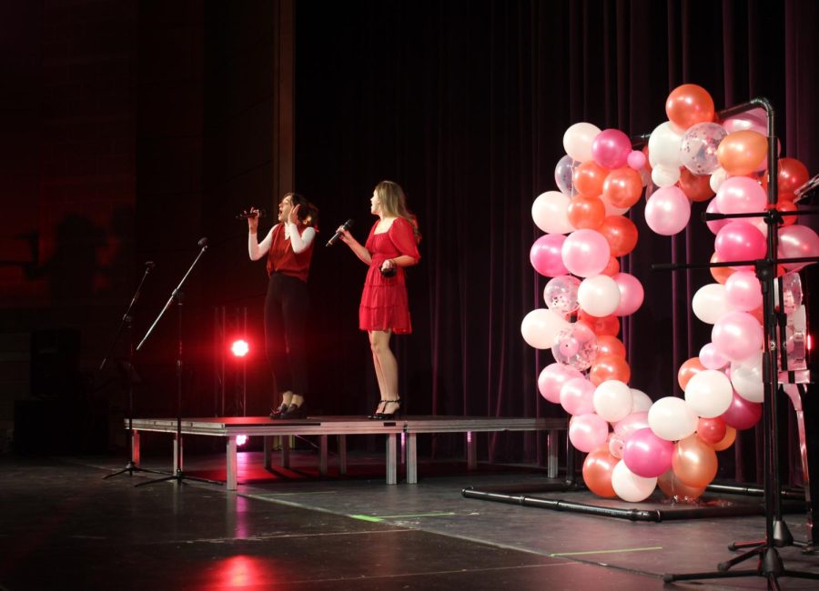 Two singers warm up on the stage before the Sweetheart Showcase.
