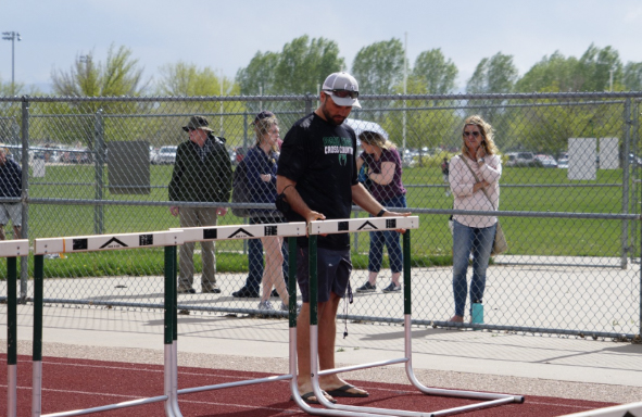 Coach Waters setting up hurdles on the Fossil Ridge High School track.