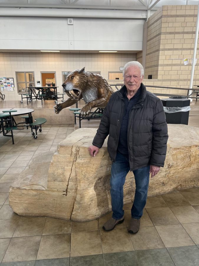 Scott Johnson in front of Fossil Ridge Sabercat Sculpture