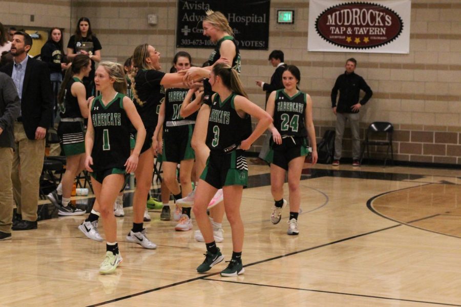 The girls basketball team celebrating their upset victory against fourth-seeded Monarch.