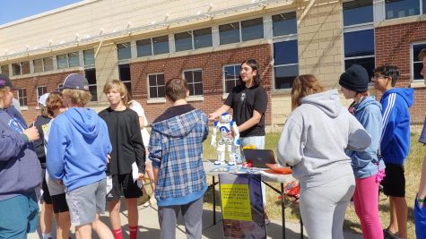 Kerem Gurkan, president of Fossil's Computer Science Honor Society, advertises for the club at Club Rush. 