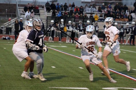 Senior Brady Hintz blowing by a Columbine player during their senior night victory.
