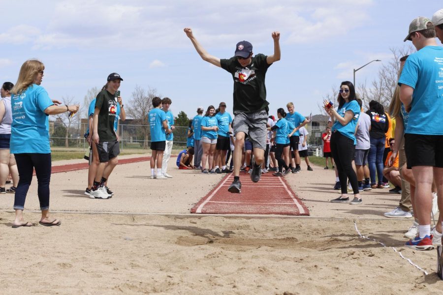 A Fossil student leaps into the sand pit after getting a running start from the track.