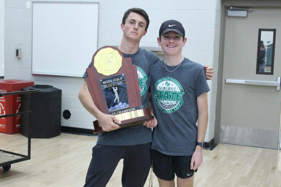 Senior Grant Samuelson (Left) and freshman Landon Houska (Right) standing with the championship trophy.