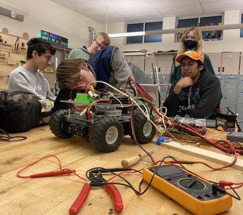 Ridgebotics students work on electrical wiring for a prototype.