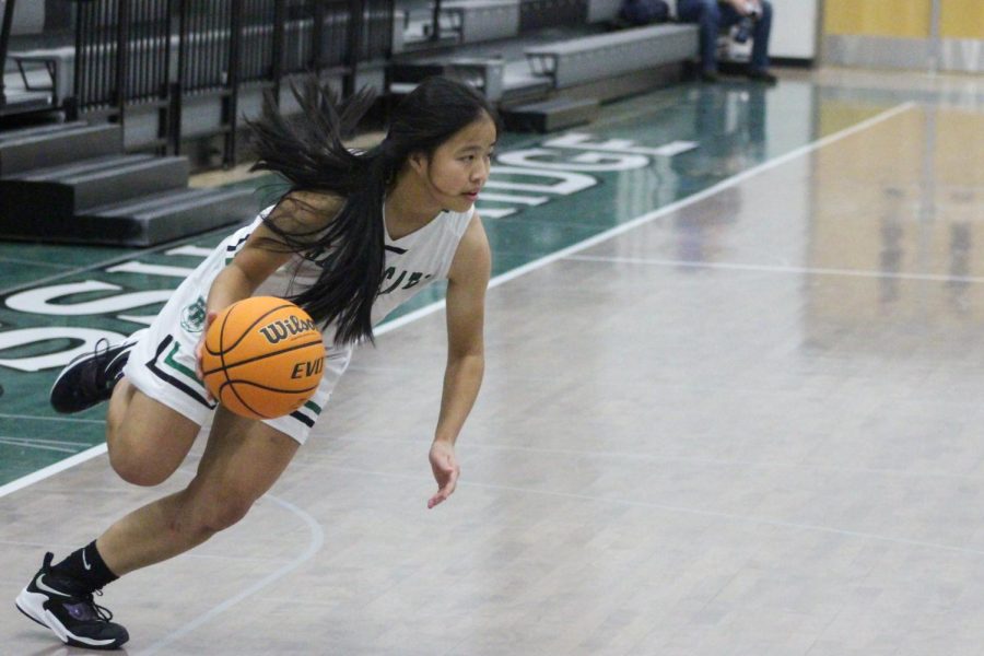 Senior guard Natatlie Lin driving with the ball in a game against Broomfield.