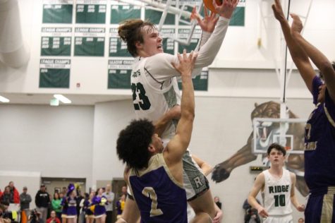 Domenic Leone rising up for a heavily contested layup against two Fort Collins defenders.