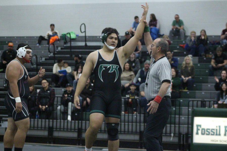 Senior Thomas Iverson celebrating a win during a dual against Berthoud.