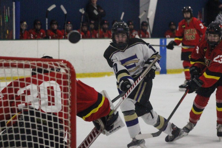 A Fort Collins hockey player attempting a shot during a home game against Castle View.