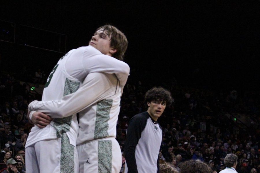 Larson(left) hugging Leone late in the fourth quarter after being subbed out.