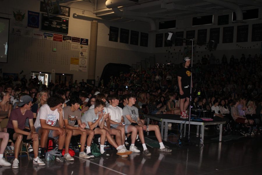 After seniors settle into their chairs in the middle of the gym, students wait in anticipation for the assembly to begin.