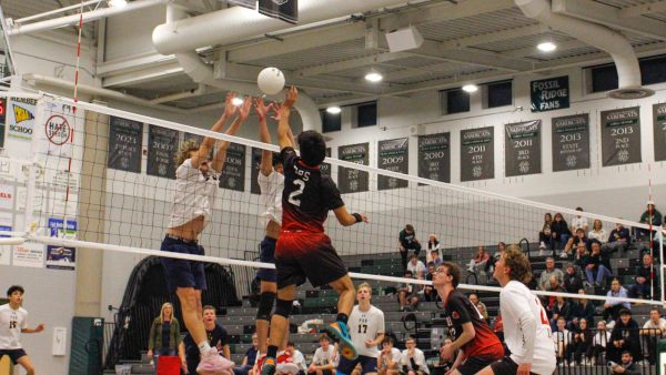 Tannor Christians and Trevor Baldwin block a Denver East spike, earning them the point.