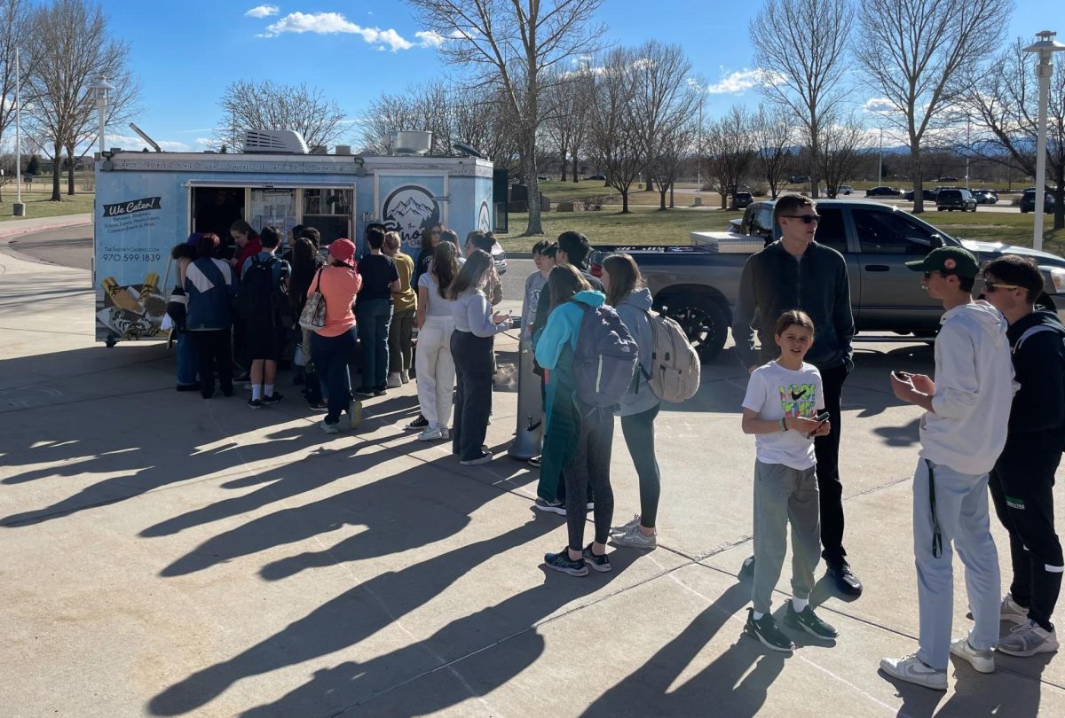 Students line up for the Snowy Churro in the front of Fossil Ridge High School.