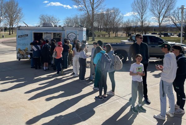 Students line up for the Snowy Churro in the front of Fossil Ridge High School.