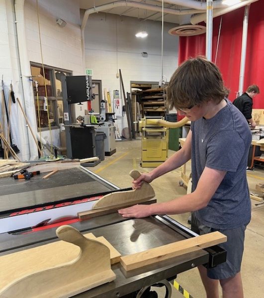Sophomore Adam Aldridge uses a table saw in Woodshop