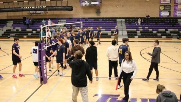 The volleyball teams shaking hands after the game 