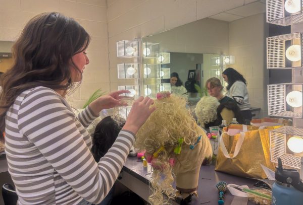 Grace Ayer and Juliana Smith work on a step-sisters and Cinderella’s stepmothers wig respectively.